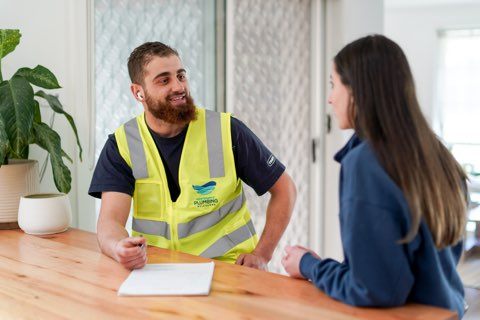 Plumber and customer talking